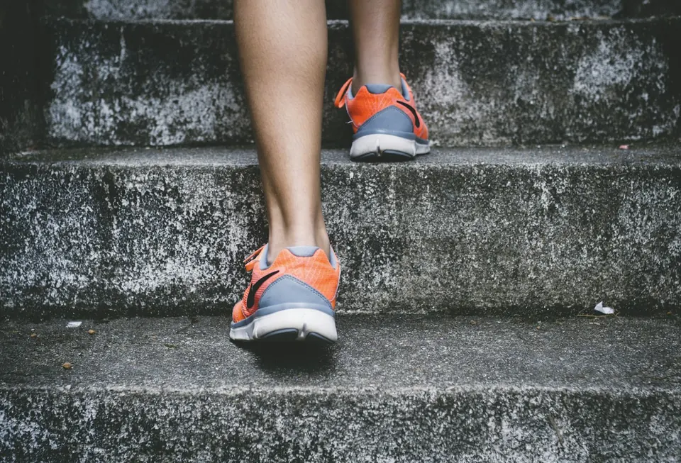 A runner climbing outdoor steps